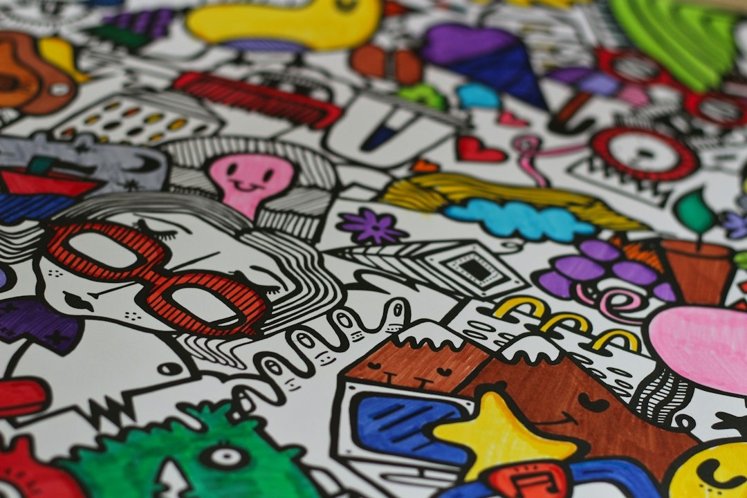 Colorful hand-drawn doodle art pattern on a white surface.
